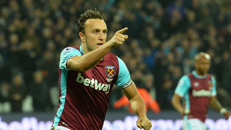 West Ham United's English midfielder Mark Noble celebrates after scoring the opening goal from the penalty spot during the English Premier League football 