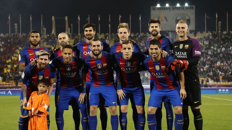 Afghan boy Murtaza Ahmadi poses for a picture with the FC Barcelona team