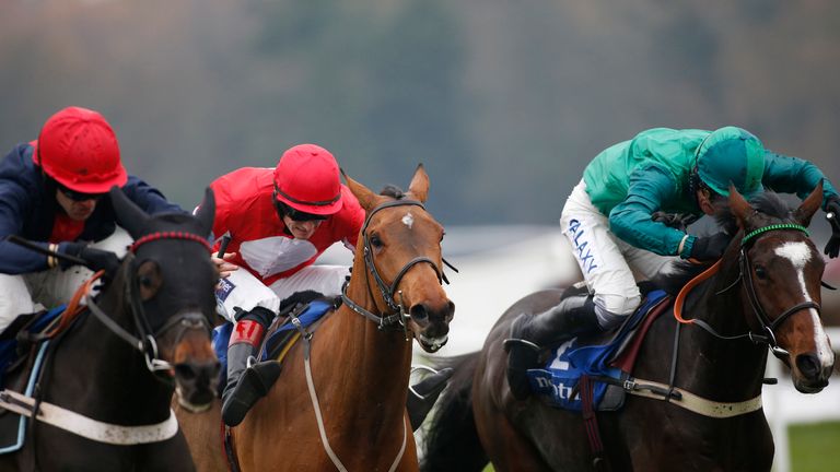 Daryl Jacob and Messire Des Obeaux (right) get the best of a tussle with Cultivator (l) and Ballyandy (c) to win the Neptune Investment Hurdle at Sandown.