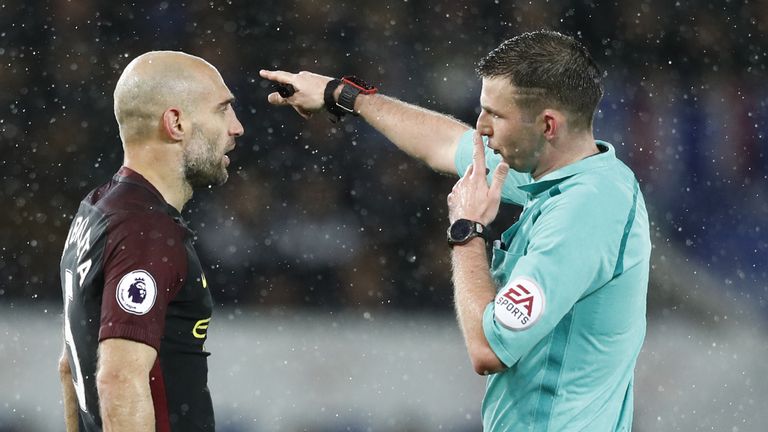 Referee Michael Oliver gestures to Manchester City's Argentinian defender Pablo Zabaleta during the English Premier League football match between Leicester