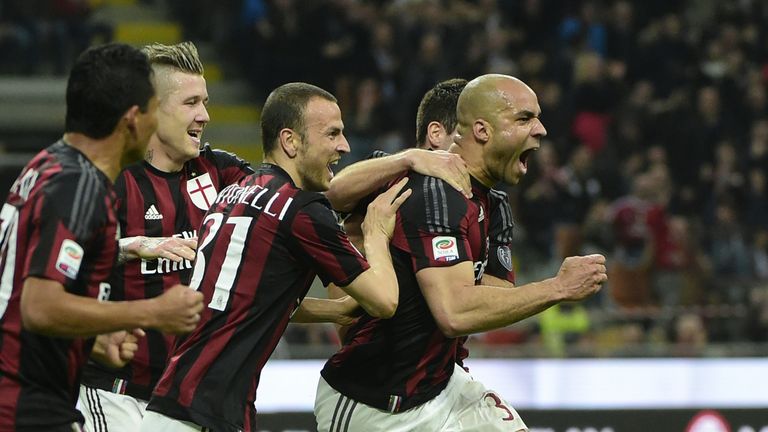 AC Milan's Brazilian defender Alex (R) celebrates with  teammates after scoring a goal  during the Italian Serie A football match between AC Milan and Juve