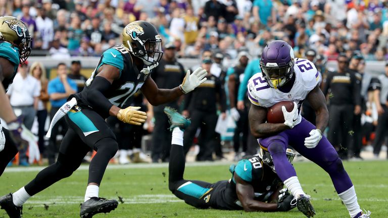 JACKSONVILLE, FL - DECEMBER 11:   Jerick McKinnon #21 of the Minnesota Vikings runs the ball as Jalen Ramsey #20 of the Jacksonville Jaguars
closes in duri