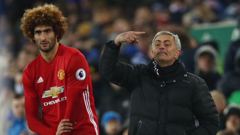 LIVERPOOL, ENGLAND - DECEMBER 04:  Jose Mourinho manager of Manchester United stands alongside his substitute Marouane Fellaini of Manchester United during