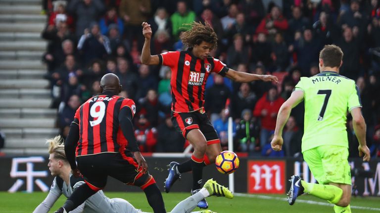 Loris Karius (left) spilled Steve Cook's shot, allowing Ake (centre) to tap home