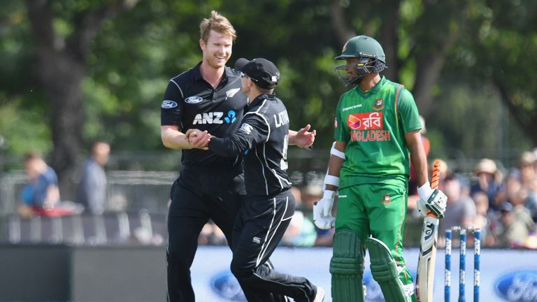 CHRISTCHURCH, NEW ZEALAND - DECEMBER 26: James Neesham of New Zealand is congratulated by Tom Latham of New Zealand (L-R) after dismissing Tamim Iqbal of B