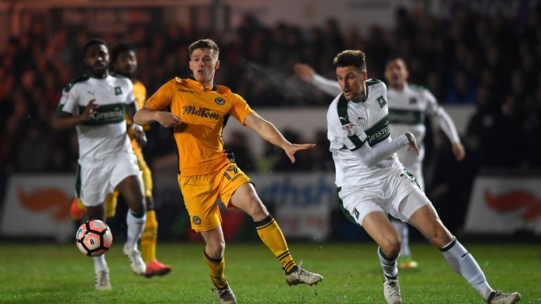 NEWPORT, WALES - DECEMBER 21:  Newport player Rhys Healey (l) challenges Sonny Bradley of Plymouth during The Emirates FA Cup Second Round Replay between N
