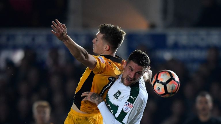 NEWPORT, WALES - DECEMBER 21:  Newport player Rhys Healey (l) challenges Sonny Bradley of Plymouth during The Emirates FA Cup Second Round Replay between N