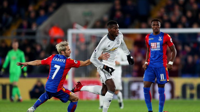 LONDON, ENGLAND - DECEMBER 14: Paul Pogba of Manchester United (C) attempts to take the ball past Yohan Cabaye of Crystal Palace (L) and Wilfried Zaha of C