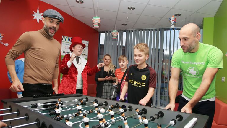 Pep Guardiola (in hat) and Pablo Zabaleta showcase their table football skills