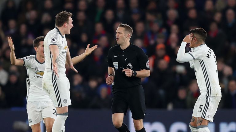 LONDON, ENGLAND - DECEMBER 14: Phil Jones of Manchester United (L) and Marcos Rojo of Manchester United (R) argue with the referee after there was no penal