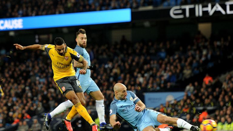 Theo Walcott puts Arsenal 1-0 up in the first half at the Etihad Stadium