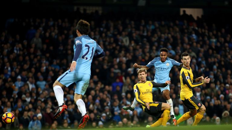 MANCHESTER, ENGLAND - DECEMBER 18: Raheem Sterling of Manchester City (R) scores his sides second goal during the Premier League match between Manchester C