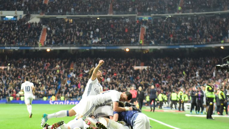 Real Madrid's defender Sergio Ramos celebrates with teammates after scoring a late winner against Deportivo
