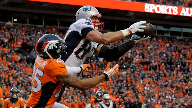 DENVER, CO - JANUARY 24:  Rob Gronkowski #87 of the New England Patriots catches a 4-yard touchdown pass late in the fourth quarter against  Chris Harris #