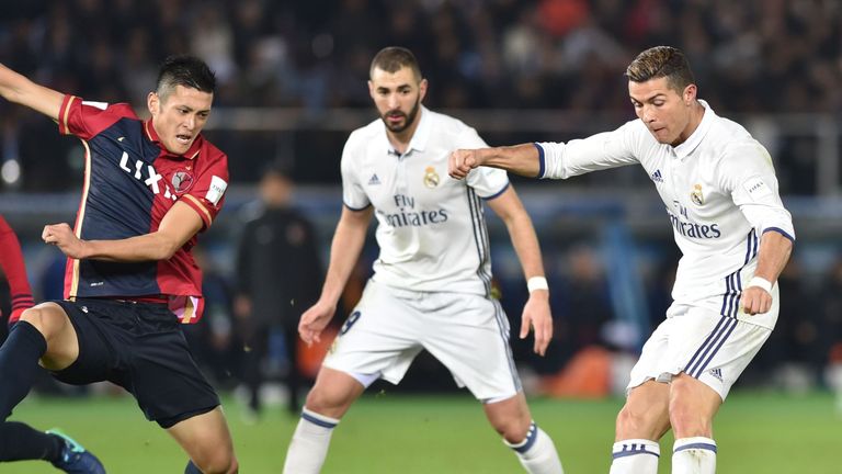 Real Madrid forward Cristiano Ronaldo (R) scores during extra-time of the Club World Cup football final match between Kashima Antlers of Japan and Real Mad