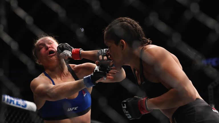 Ronda Rousey (L) takes some early punishment from Amanda Nunes on Friday