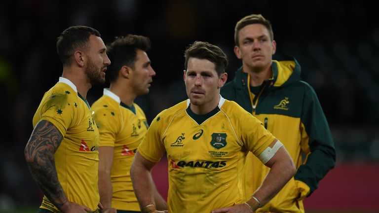 Wallabies fly-half Bernard Foley (second from right) looks dejected after their defeat to England