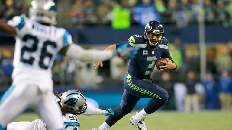 SEATTLE, WA - DECEMBER 04:  Quarterback Russell Wilson #3 of the Seattle Seahawks rushes against the Carolina Panthers at CenturyLink Field on December 4, 