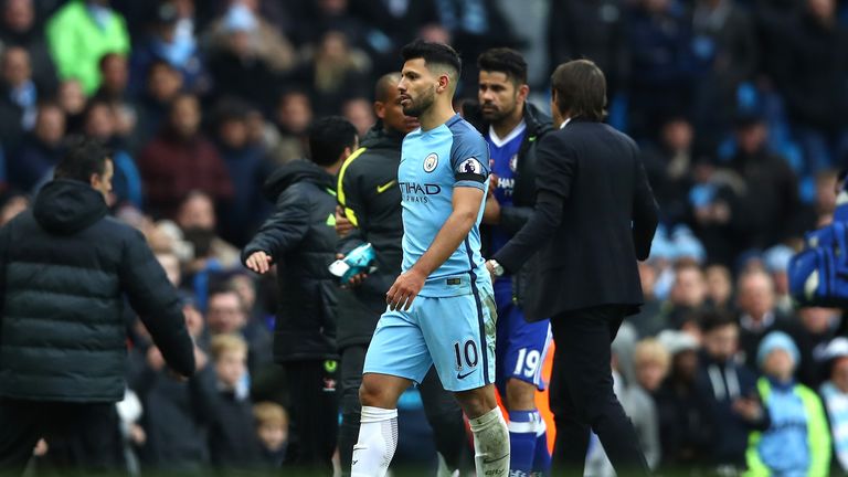 Sergio Aguero of Manchester City walks off the pitch after he was sent off against Chelsea as Diego Costa looks on