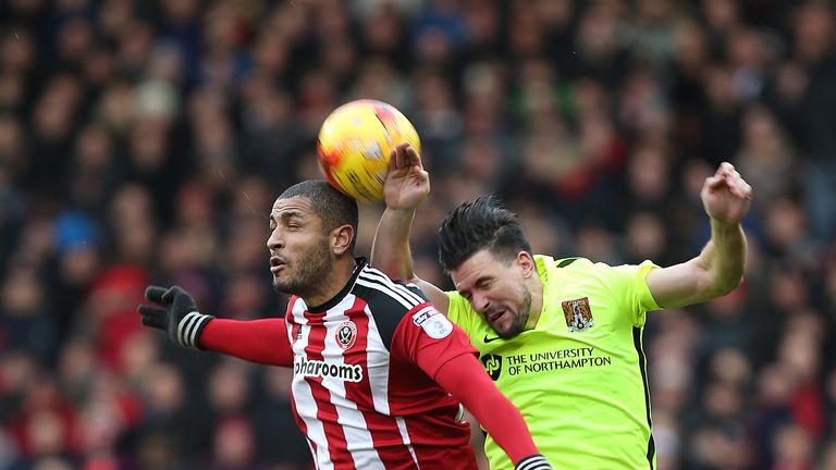 David Buchanan of Northampton Town contests the ball with Leon Clarke of Sheffield United during the Sky Bet League One 