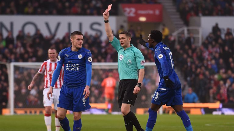 Referee Craig Pawson shows a red card to Leicester striker Jamie Vardy