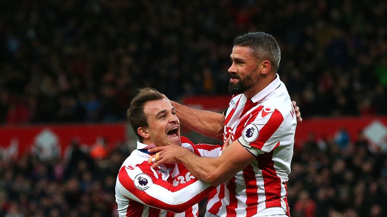 STOKE ON TRENT, ENGLAND - DECEMBER 03:  Jonathan Walters (R) of Stoke City celebrates scoring his team's first goal with his team mates Xherdan Shaqiri (L)