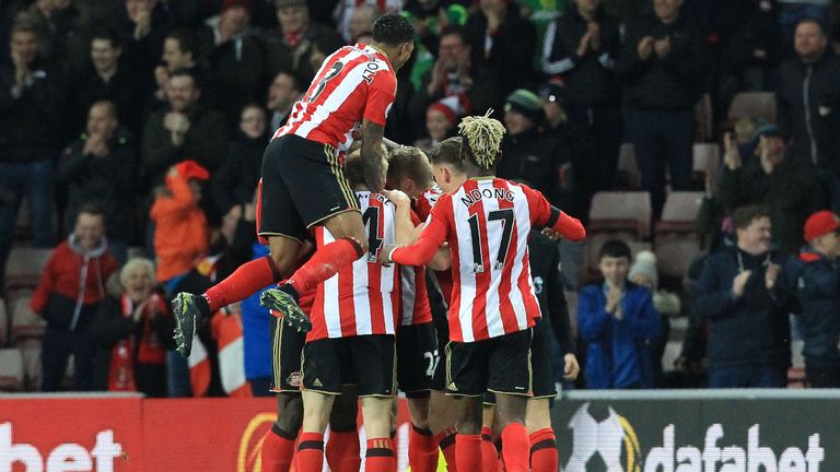 Sunderland players celebrate after a header from Sunderland's German defender Jan Kirchhoff caused Leicester City's German defender Robert Huth to socre an