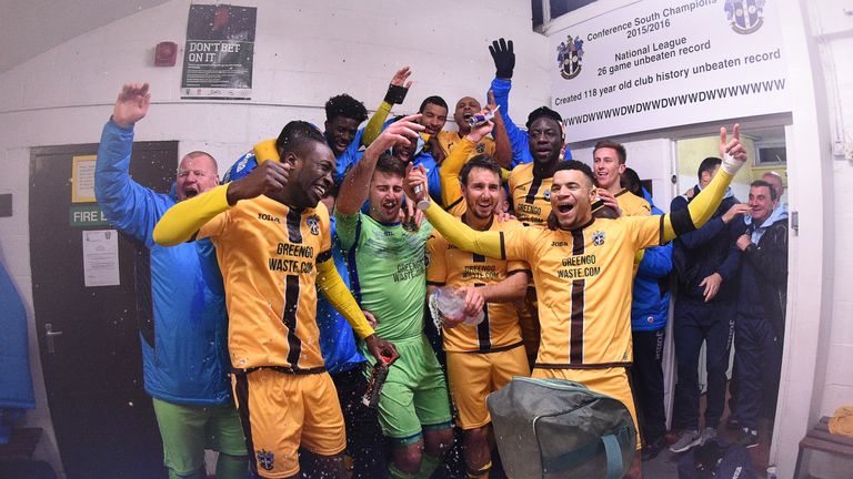 The players of Sutton United celebrate in the changing room after beating Cheltenham Town in the Emirates FA Cup