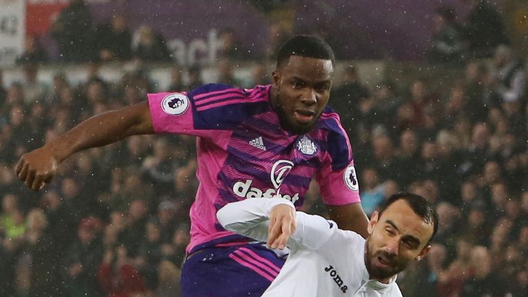 Sunderland's Nigerian striker Victor Anichebe (L) vies with Swansea City's English midfielder Leon Britton during the English Premier League football match