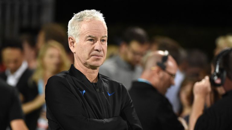 Former tennis player John McEnroe stands on the court during the World TeamTennis Smash Hits charity tennis event
