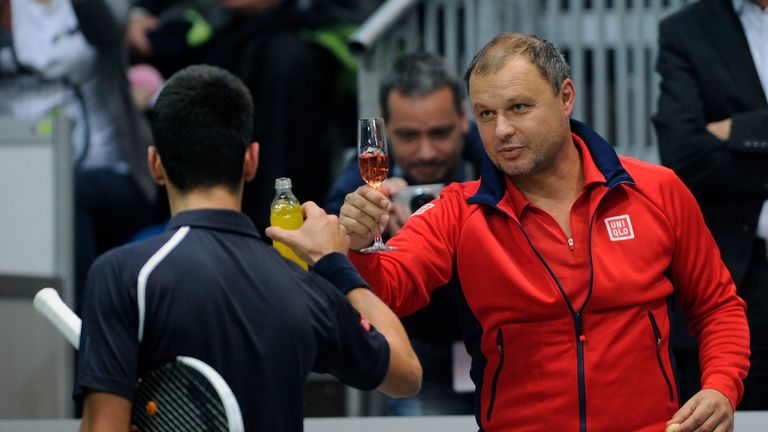 Serbia's tennis player Novak Djokovic (L) toasts with his coach Marian Vajda (R) during a Tennis Classic exhibition match