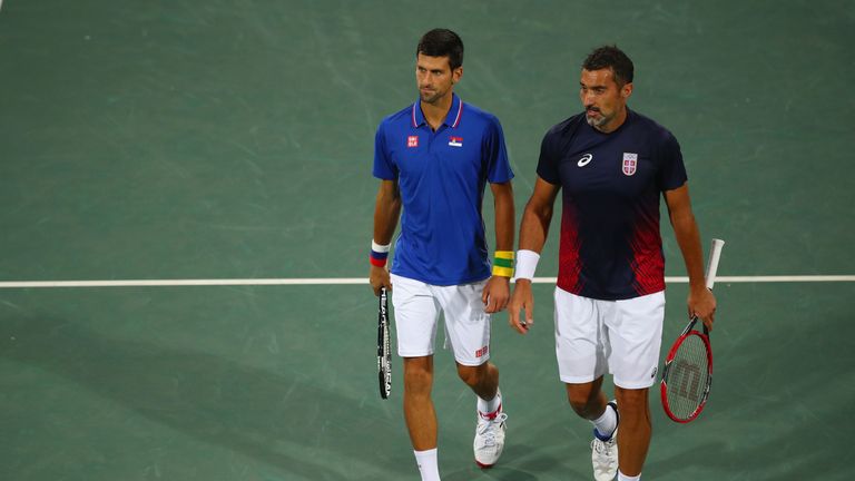 Novak Djokovic and Nenad Zimonjic of Serbia in discussion during the Men's Doubles second round match