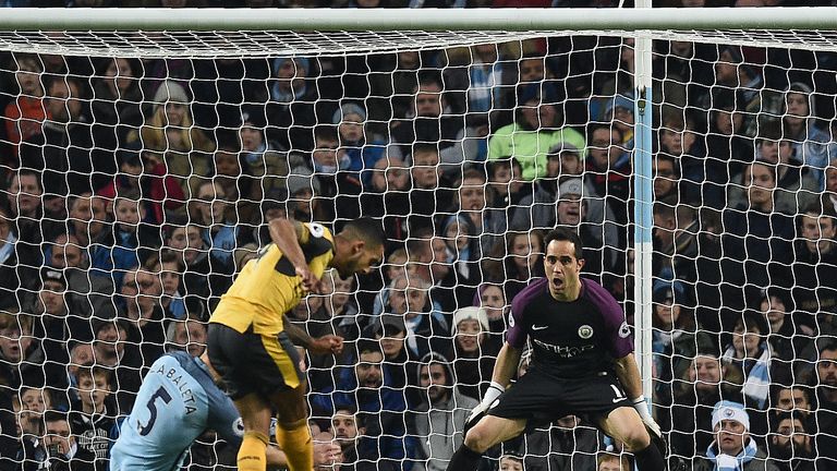 Arsenal's English midfielder Theo Walcott (C) scores his team's first goal past Manchester City's Chilean goalkeeper Claudio Bravo 
