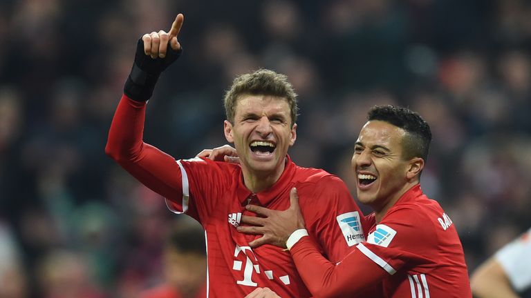 Bayern Munich's striker Thomas Mueller (L) and Bayern Munich's Spanish midfielder Thiago Alcantara (R) celebrate after the third goal for Munich during the
