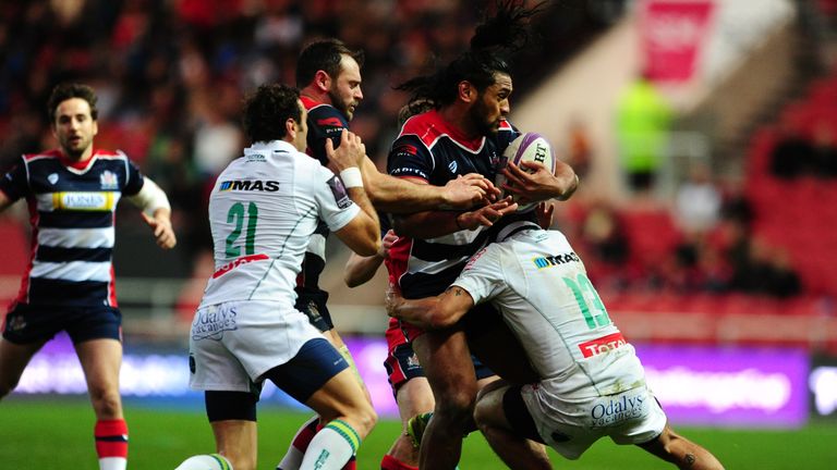 BRISTOL, UNITED KINGDOM - DECEMBER 11: Thretton Palamo of Bristol Rugby is tackled by Julien Fumat of Pau during the European Rugby Challenge Cup match bet