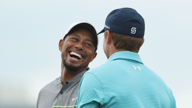 NASSAU, BAHAMAS - DECEMBER 03:  Tiger Woods of the United States and Jordan Spieth of the United States laugh on the practice range during round three of t