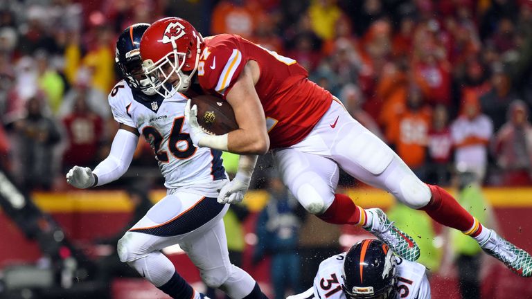 KANSAS CITY, MO - DECEMBER 25:  Tight end Travis Kelce #87 of the Kansas City Chiefs carries the ball after catching a pass as free safety Darian Stewart #