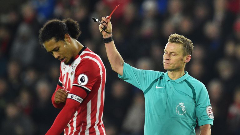 Virgil van Dijk receives a red card from referee Mike Jones
