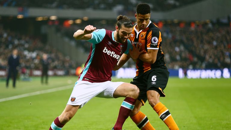 Andy Carroll of West Ham and Hull's Curtis Davies battle for the ball