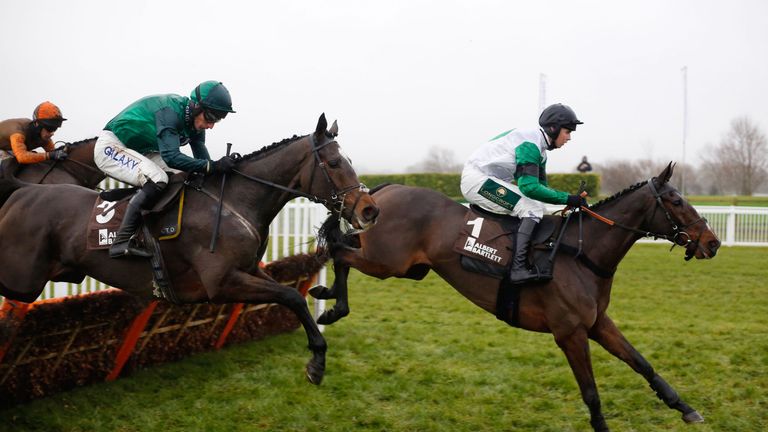 Wholestone ridden by Daryl Jacob trails Ami Desbois ridden by Kielan Woods over an early flight before going on to win The Albert Bartlett Novices' Hurdle 