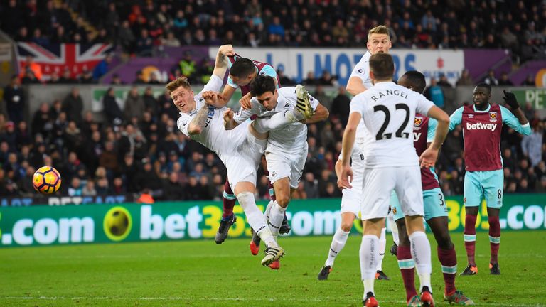 SWANSEA, WALES - DECEMBER 26:  Winston Reid of West Ham United scores his team's second goal with a header during the Premier League match between Swansea 