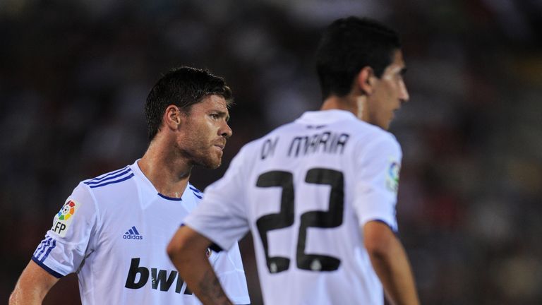 Xabi Alonso (L) of Real Madrid stands flanked by his team-mate Angel Di Maria