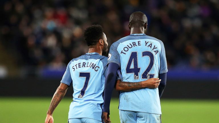 Yaya Toure celebrates his goal with team-mate Raheem Sterling