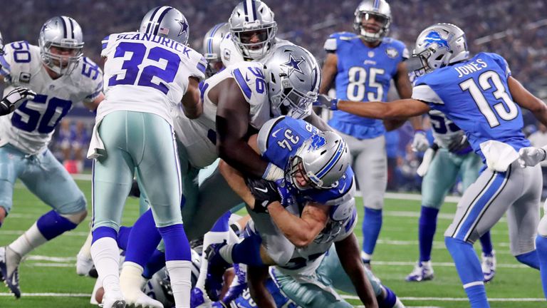 ARLINGTON, TX - DECEMBER 26: Zach Zenner #34 of the Detroit Lions scores on a touchdown run as Maliek Collins #96 of the Dallas Cowboys tries to stop him d