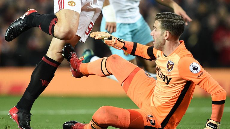 Manchester United's Swedish striker Zlatan Ibrahimovic (L) clashes with West Ham United's Spanish goalkeeper Adrian after scoring his team's first goal dur