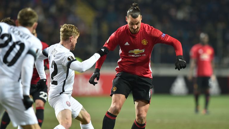 FC Zorya Luhansk midfielder Zeljko Ljubenovic (L) vies for the ball with Manchester United's Zlatan Ibrahimovic 