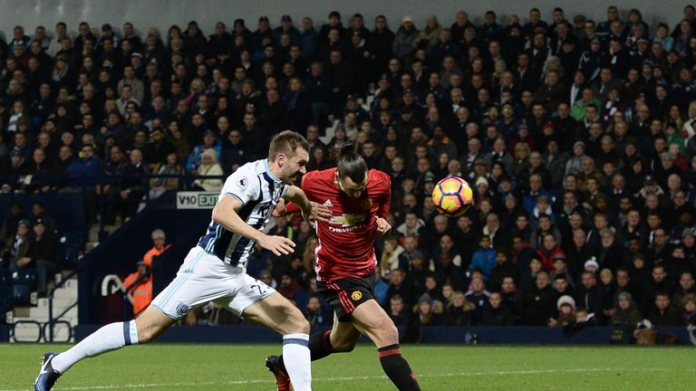 Manchester United striker Zlatan Ibrahimovic (R) gets behind West Bromwich Albion's Northern Irish defender Gareth McAuley to score the opening goal