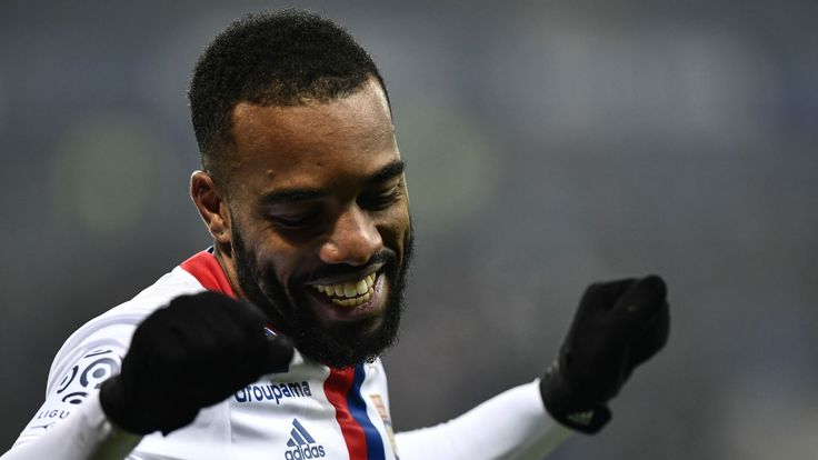 Lyon's French forward Alexandre Lacazette (L) celebrates after scoring a goal during the French L1 football match Olympique Lyonnais (OL) vs Marseille (OM)