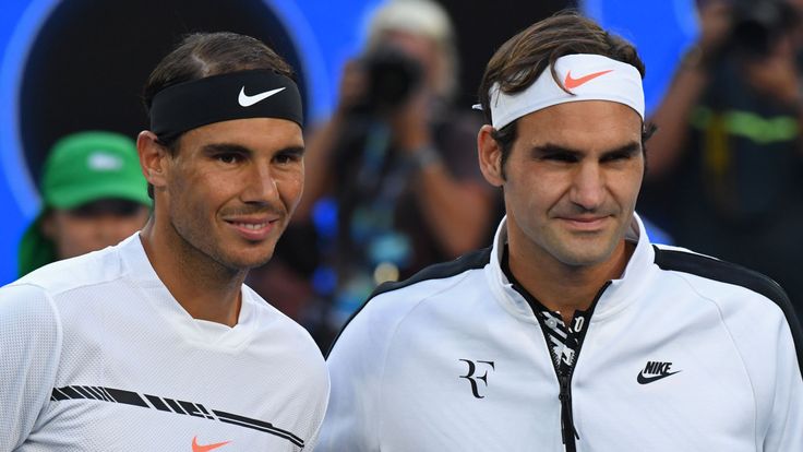 Switzerland's Roger Federer (R) and Spain's Rafael Nadal (L) pose for photographs before the men's singles final on day 14 of the Australian Open