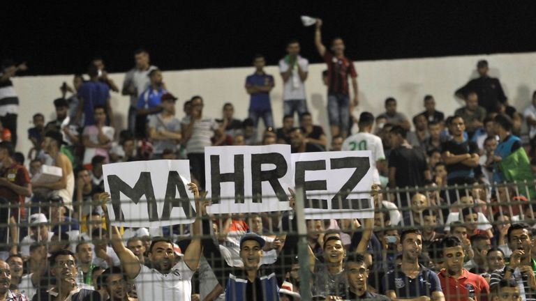 Algeria national team's supporters hold placards reading the name of player Riyad Mahrez during a 2017 African Cup of Nations qualifying football match